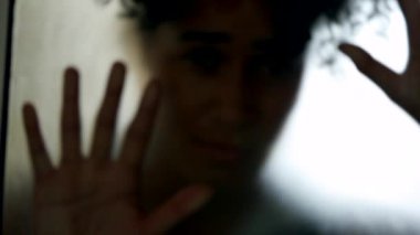 Shadow of person behind glass feeling trapped, mental illness