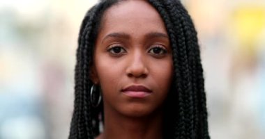 Serious teen African black girl portrait looking at camera. Young woman