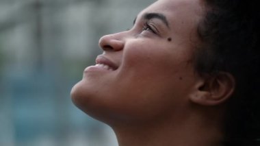 African woman face looking at sky