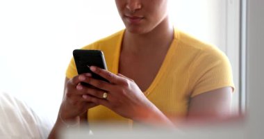 African american woman typing text message, black girl reading message on cellphone