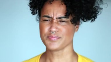 Upset Mixed race woman shaking head