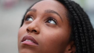 Young African black girl face looking up and closing eyes in meditation