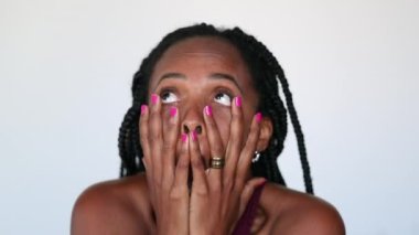 Anxious black woman reacting with despair. Crazy African person reaction