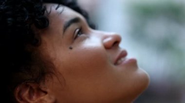 Thoughtful African woman closing eyes in meditation