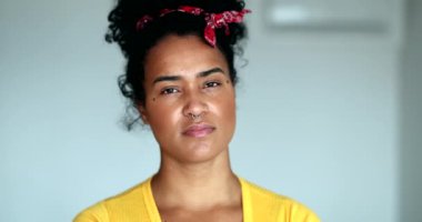 Thoughtful young black woman opening eyes to camera thinking, african american person portrait