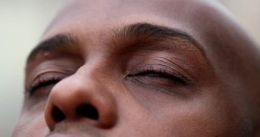 African man opening eyes close-up, black ethnicity person eye open