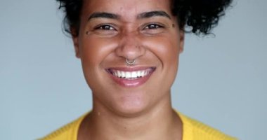 Young black woman laughing and smiling, authentic real life smile