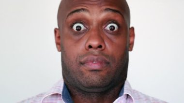 Black man shock reaction, mixed race person surprised unbelievable horror emotion