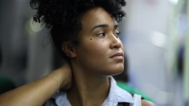 Contemplative African woman in subway train