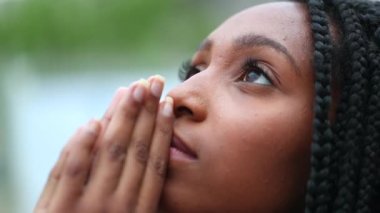 Spiritual young black woman face looking at sky with HOPE and FAITH