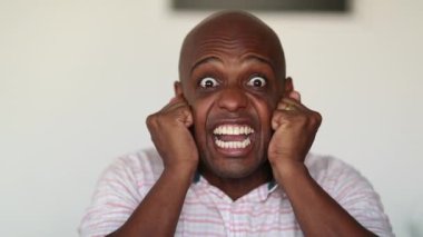 Neurotic crazy black African man reaction, aNeurotic crazy black African man reaction, close-up face mood changes-up mood changes