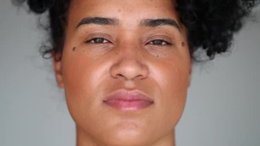 Young African American woman staring at camera with serious expression