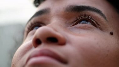 Black woman looking to sky in meditation. African woman closing eyes meditating