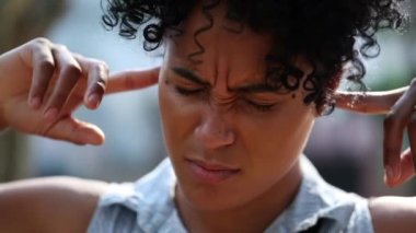 Person not wanting to listen putting finger inside ears