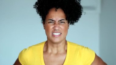 Upset black woman clenching fists, angry african person