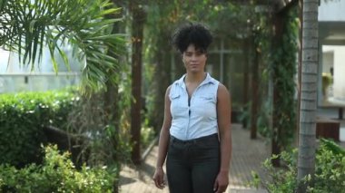 Mixed race young woman standing portrait looking at camera