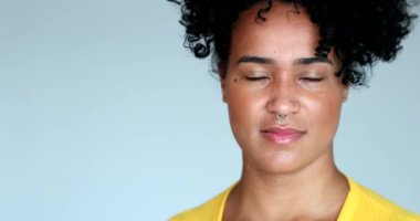 Doubtful young black woman rolling eyes