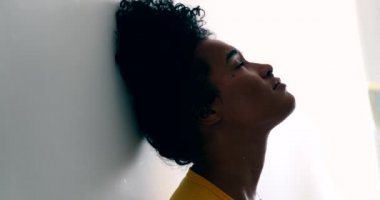 Young black woman opening eyes and looking at camera