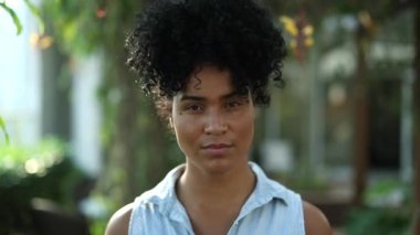 Confident young black woman walking forward. Serious African mixed race girl