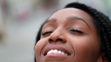 Young black woman closing eyes in meditation