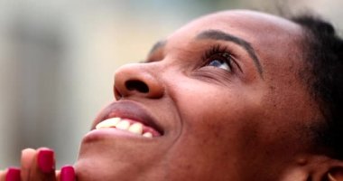 African female opening eyes to sky in peace