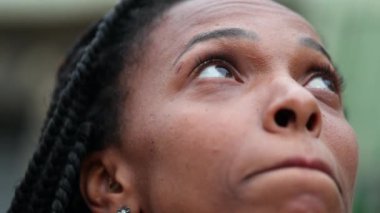 Anxious black woman closing eyes in relaxation and meditation