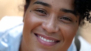 Young mixed race black woman smiling at camera