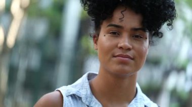 Young black woman portrait with no expression looking at camera