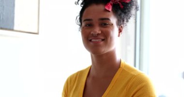 Happy excited young mixed race woman celebrating success with fist