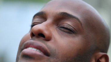 Meditative black man closing eyes in contemplation