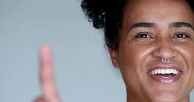 Happy young black woman laughing shaking finger saying no
