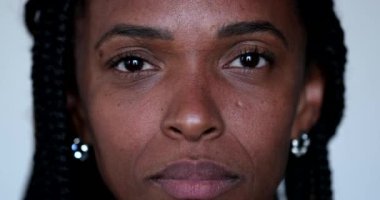 African woman closes eyes in meditation, close-up portrait face closing eye in contemplation