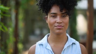 Young black woman winking to camera