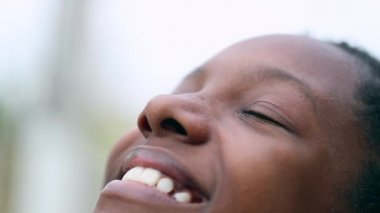 Teen black girl closing eyes in meditation