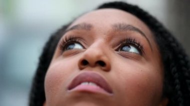 Teen black girl opening eyes to sky smiling