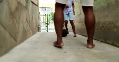 Father and child boy playing ball together at home alley