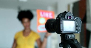 Social media influencer in front of camera at home