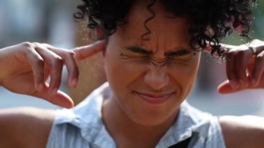 Black woman fingers in ears not wanting to listen