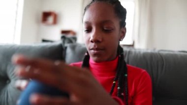 Anxious upset black african teen at home feeling bored