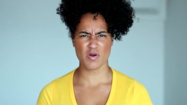 Upset black woman clenching fists, angry african person
