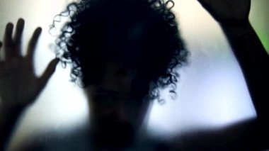 Shadow of person behind glass feeling trapped