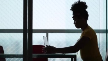 Person turning off computer, closing laptop