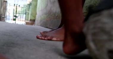 Feet and legs playing with ball, African dad and child bond