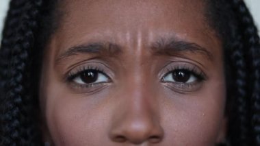 Upset black African teen close-up face and eyes. Preoccupied person