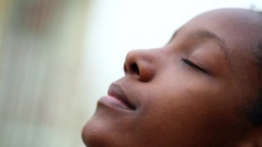 Black African girl with eyes closed in meditation