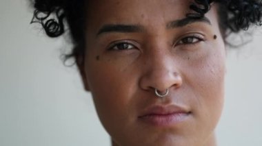 Serious young black mixed race woman portrait looking at camera