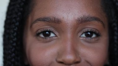 African black teen close-up face looking at camera, eyes macro