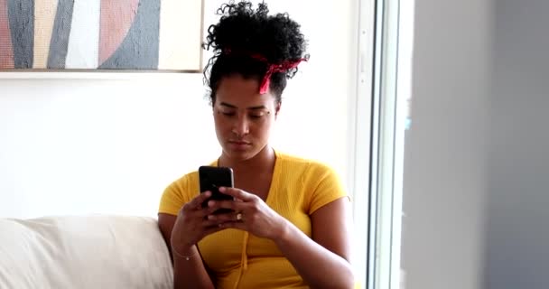 Young Black Woman Using Cellphone Home — Stock Video