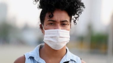 Black woman wearing face mask against virus prevention outbreak. Mixed race person