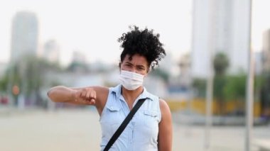 Rebellious mixed race woman raises fist in air